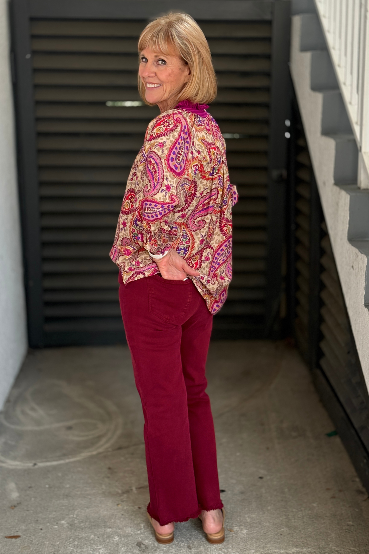 High-rise cropped flare jeans in acid-washed dark burgundy.
