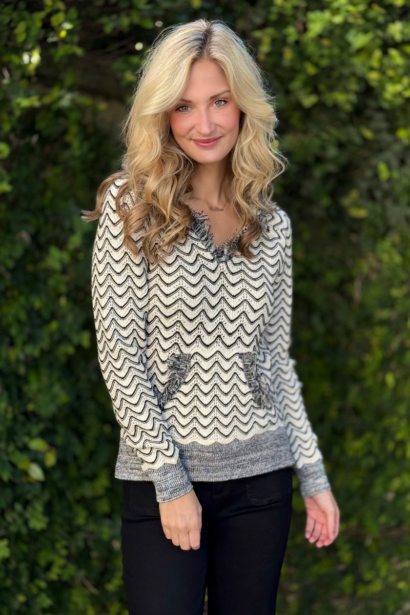 Detail of kangaroo pocket and combed cotton texture on Tribal hooded sweater