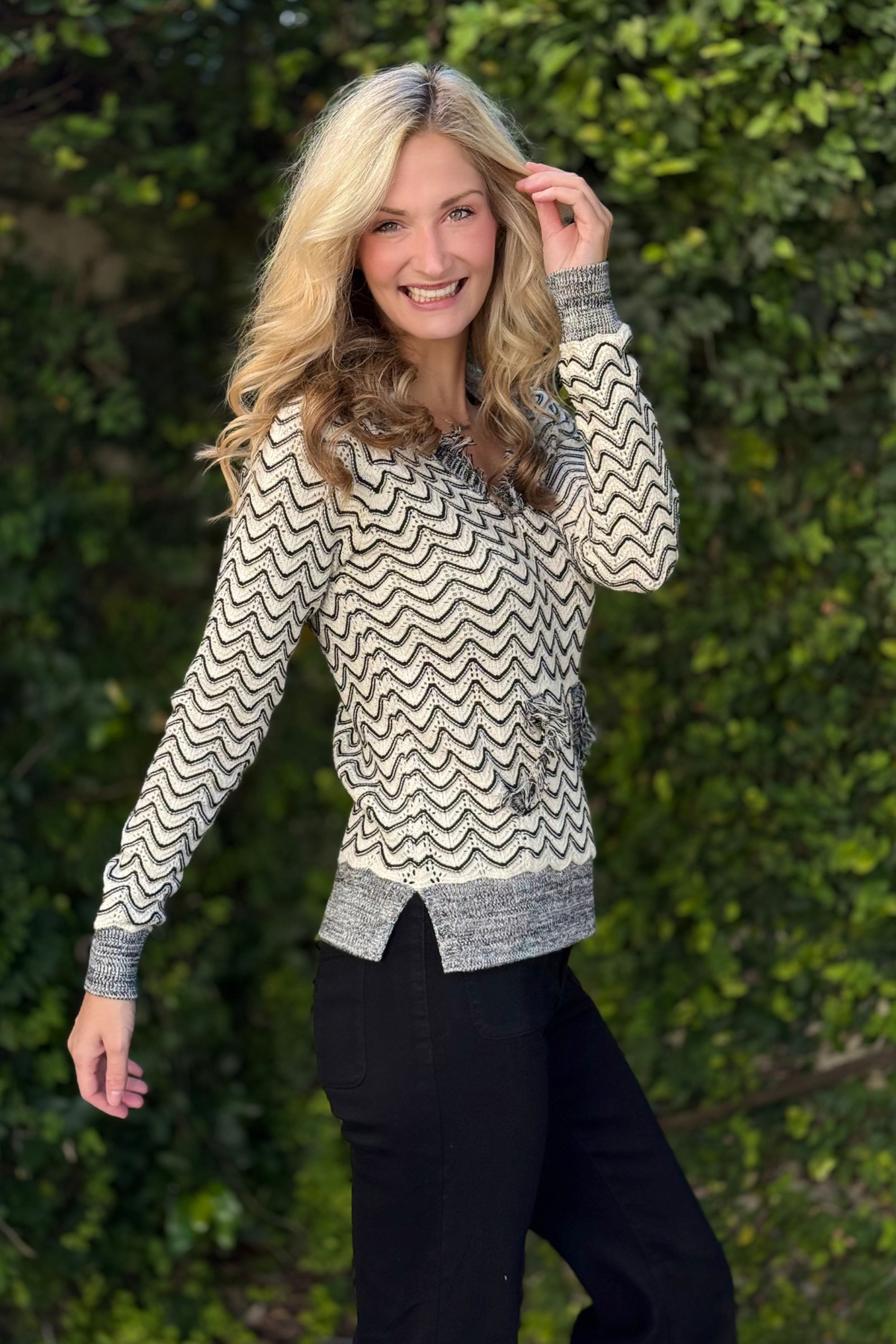 Close-up of fringe trim on H. Charcoal sweater