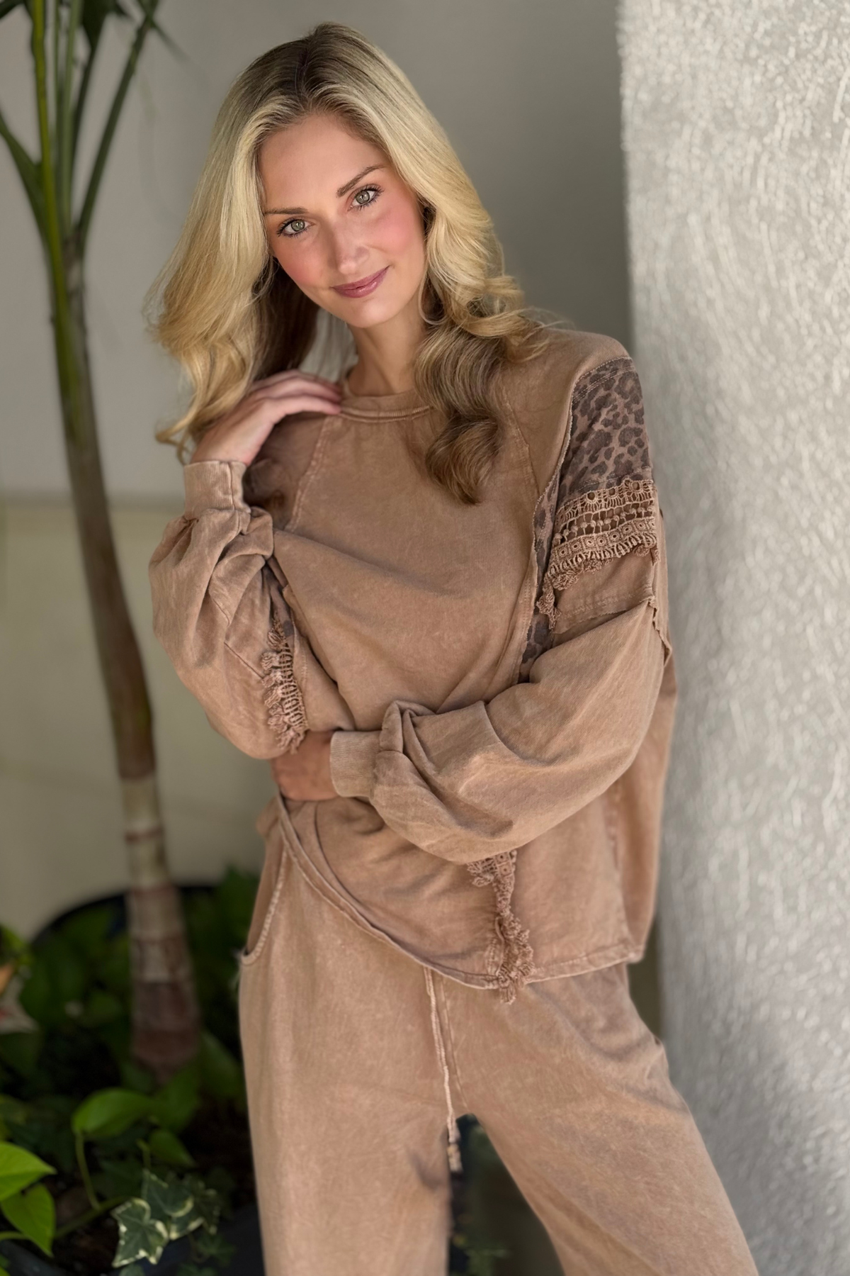 Close-up of cheetah print, lace trim, and fringe details on top