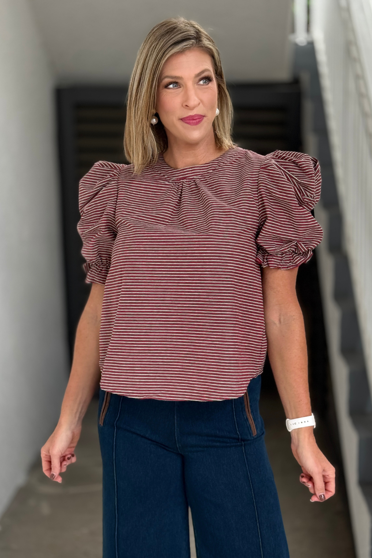 Burgundy striped top featuring ruched sleeves and ruffle cuffs