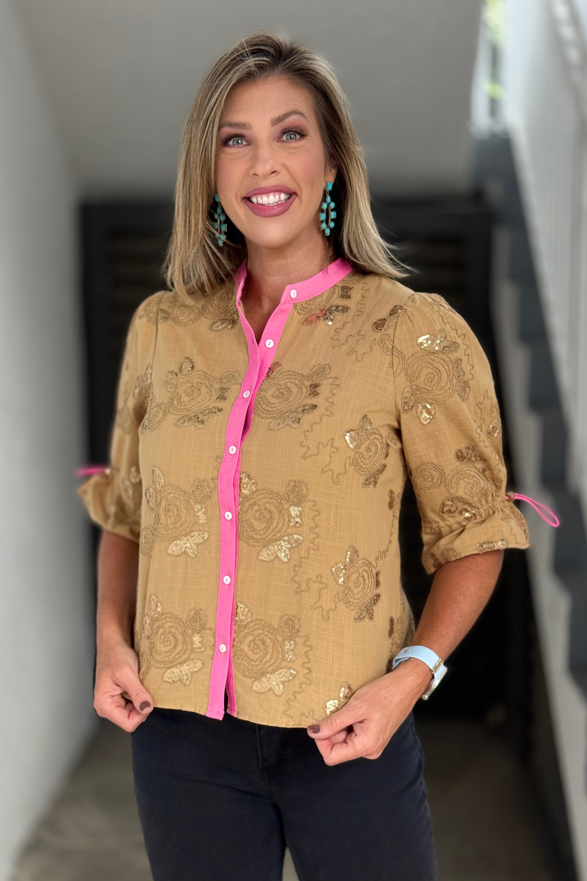 Women’s neutral embroidered blouse with pink button placket