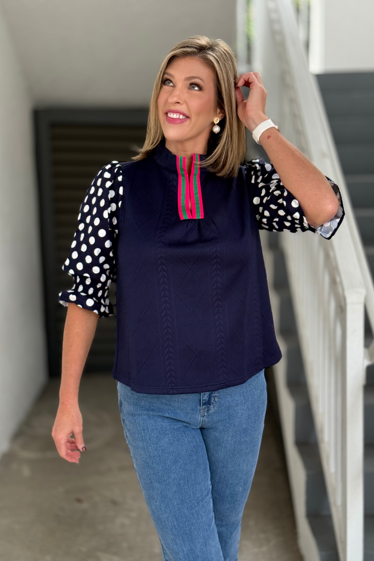 Women’s navy mixed media top with colorful split neckline trim