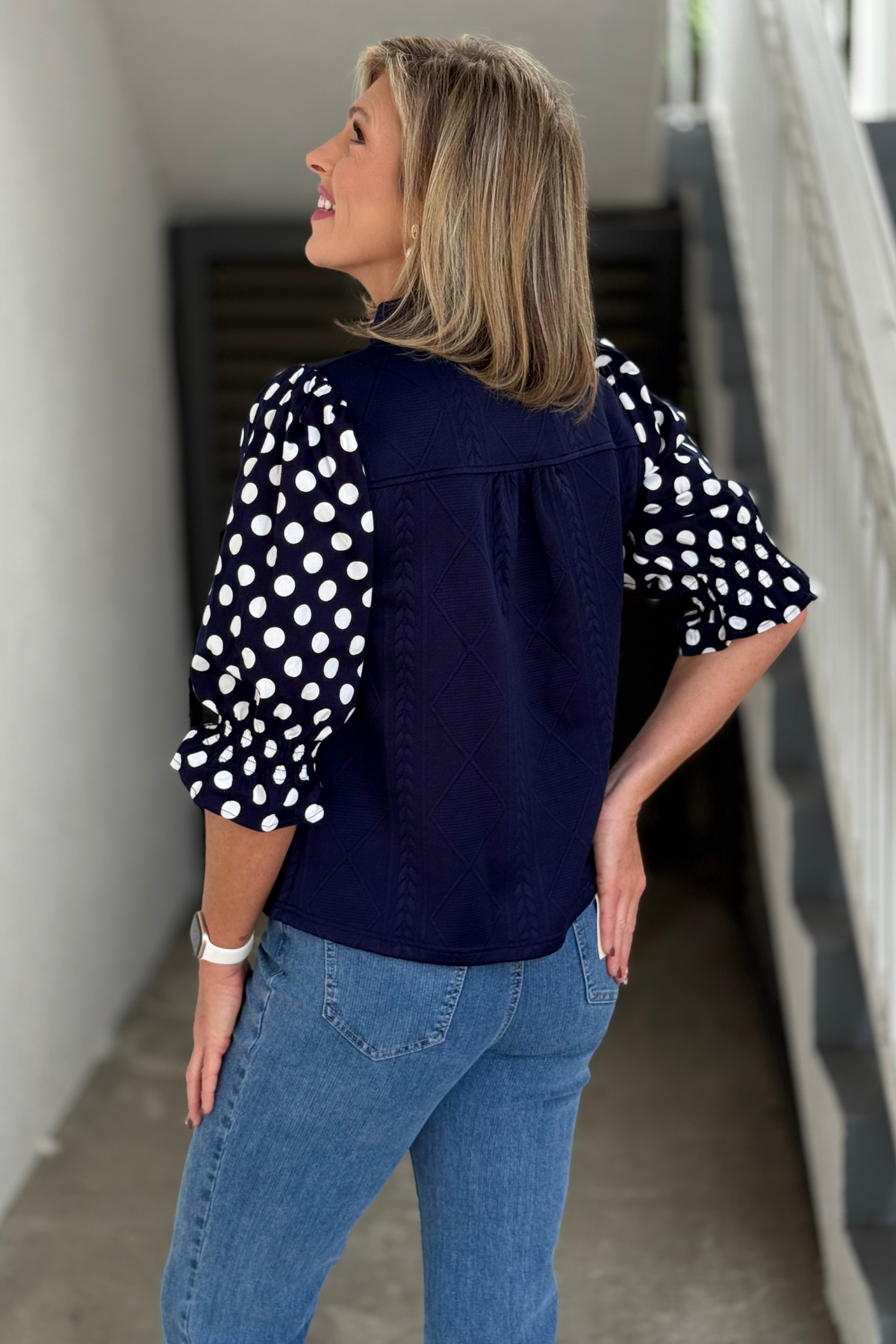 Navy braided knit top with smocked polka dot sleeves and ruffle cuffs