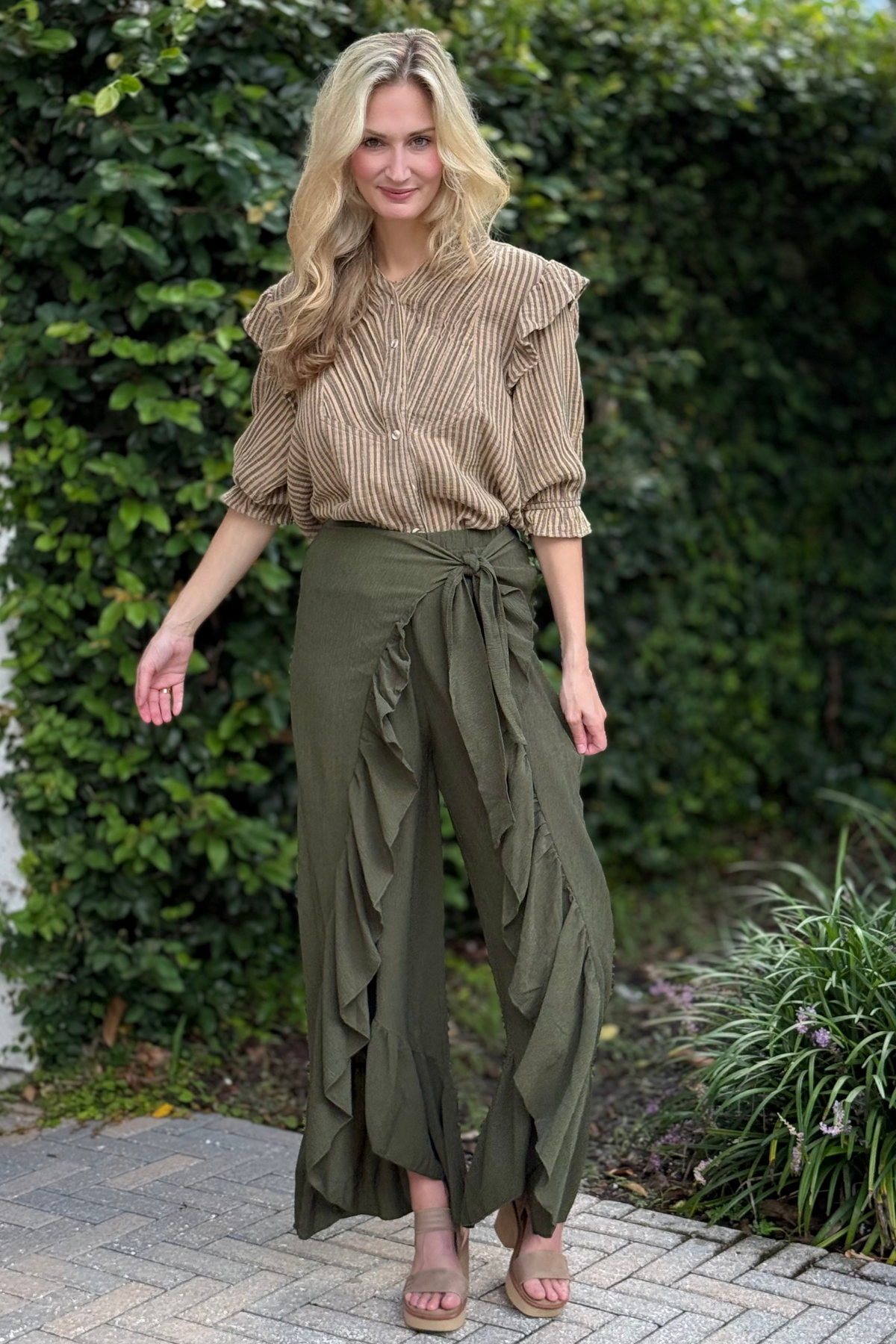 Model walking or spinning slightly to show movement of ruffle hem.