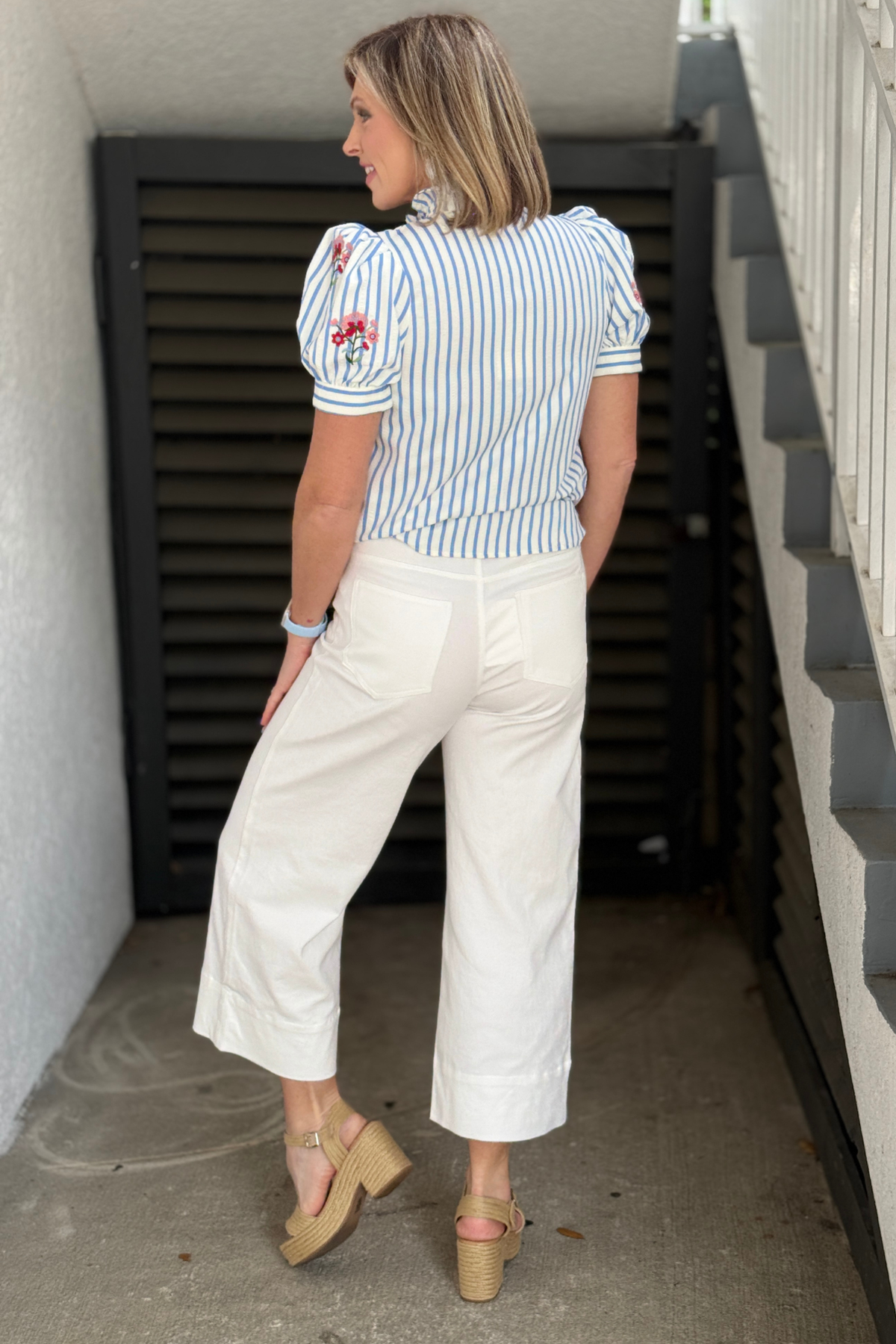 lightweight white trousers styled with blouse