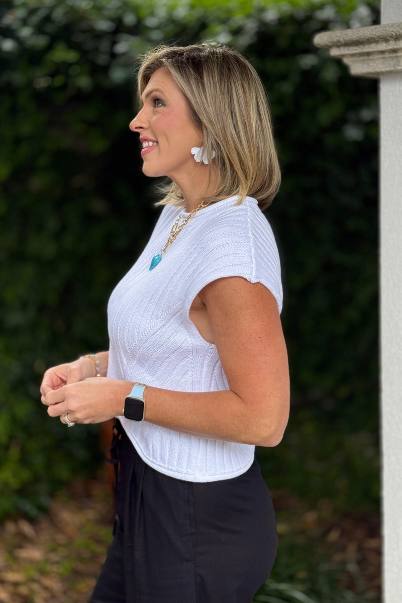 Front view of white ribbed knit top with crew neckline