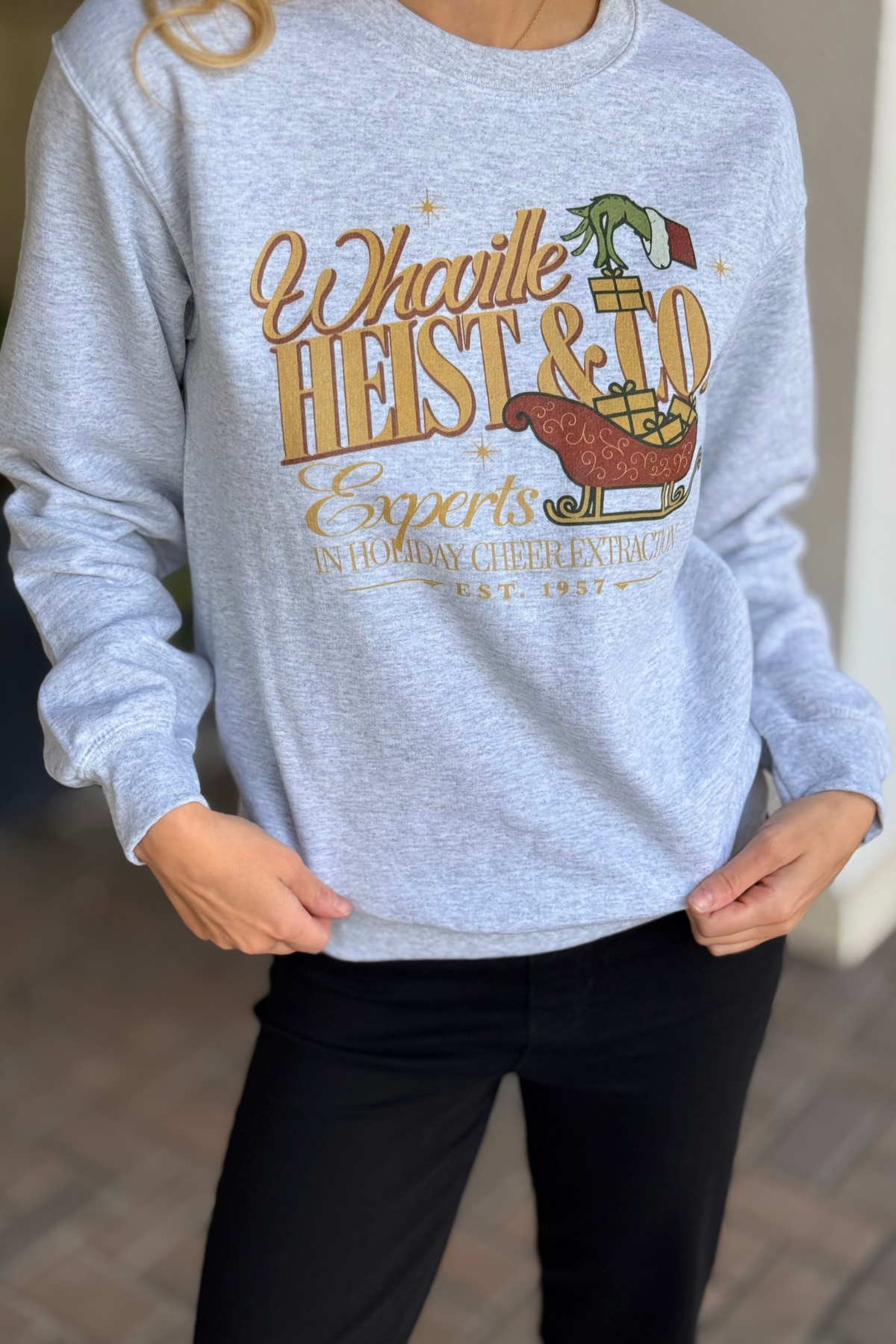 Model wearing grey Christmas Whoville crewneck sweatshirt