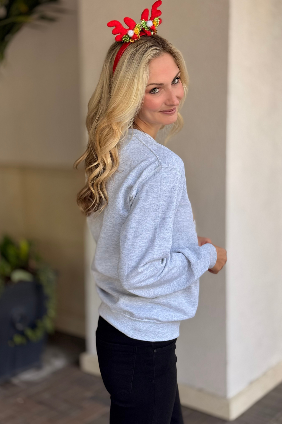 Cozy holiday crewneck sweatshirt styled with black pants