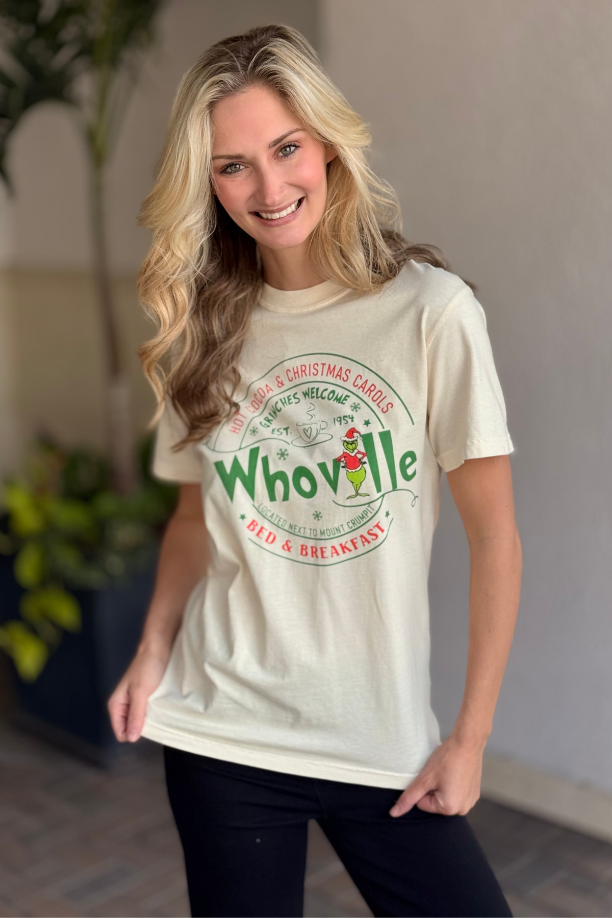 Woman styling Whoville Christmas graphic tee for the holidays