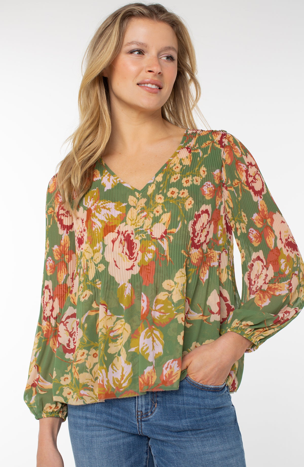 Woman wearing Liverpool Pleated Chiffon V-Neck Blouse in Green Multi Floral with blouson sleeves
