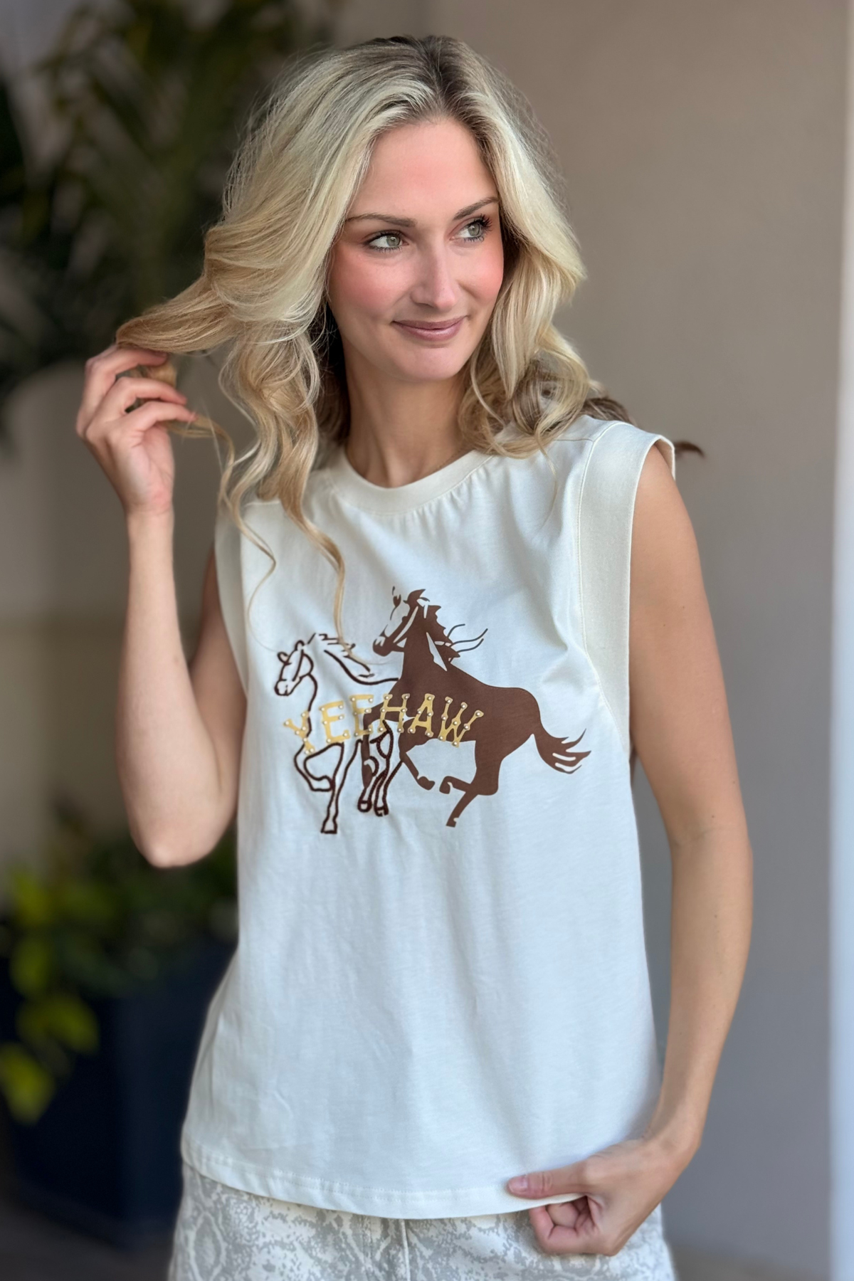 Model wearing The Wild Wanderer Yeehaw Boxy Tank with wild horse graphic front view