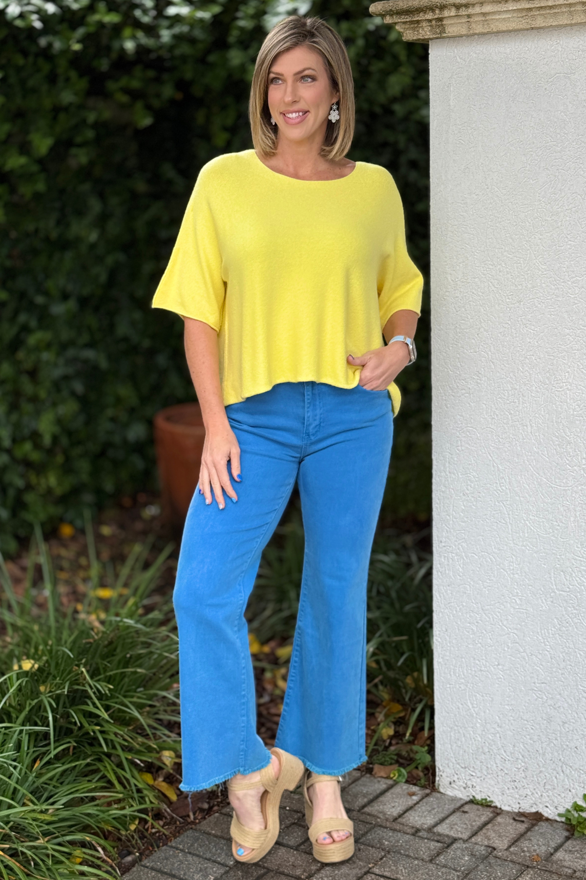 Side view of loose fit summer knit top in vibrant yellow