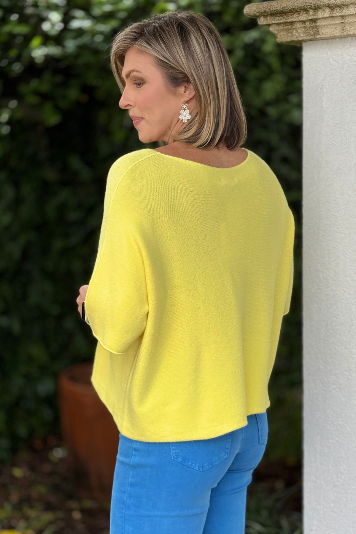 Lightweight yellow sweater layered for cool summer evenings
