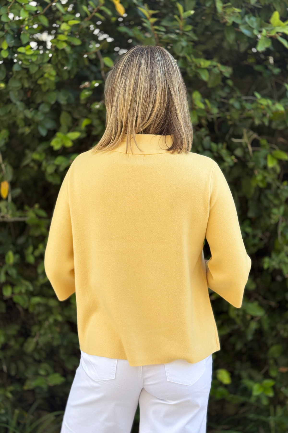 Spring yellow pullover sweater styled with white denim