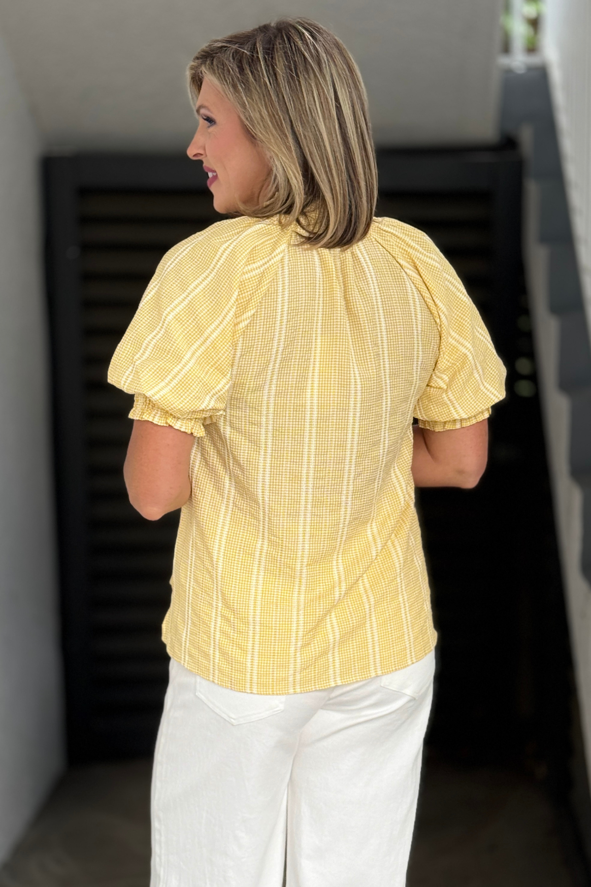 Yellow boutique top with ruffle details and puff sleeves
