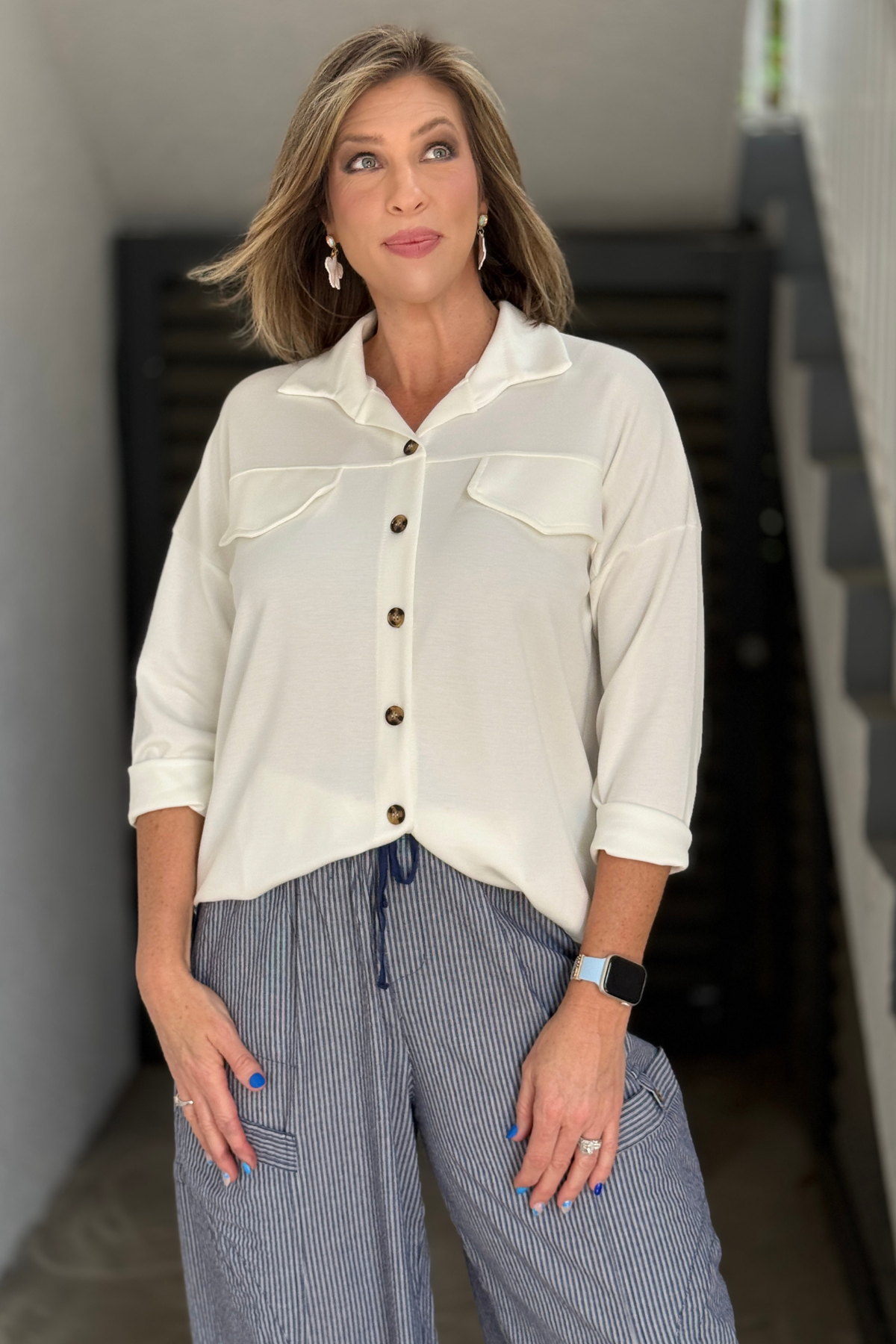 lightweight women’s button down blouse styled with striped pant