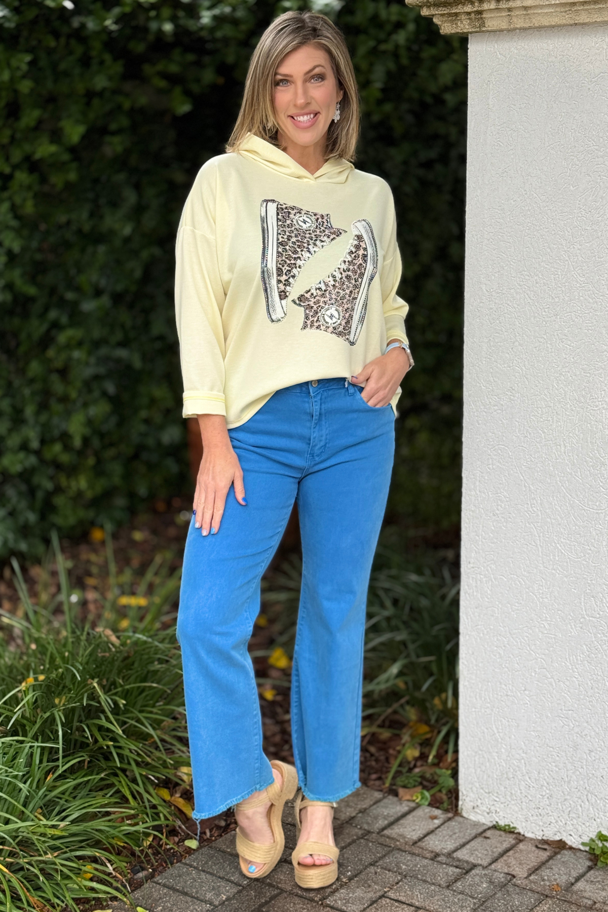 Sporty chic graphic hoodie styled with wide leg denim and wedges