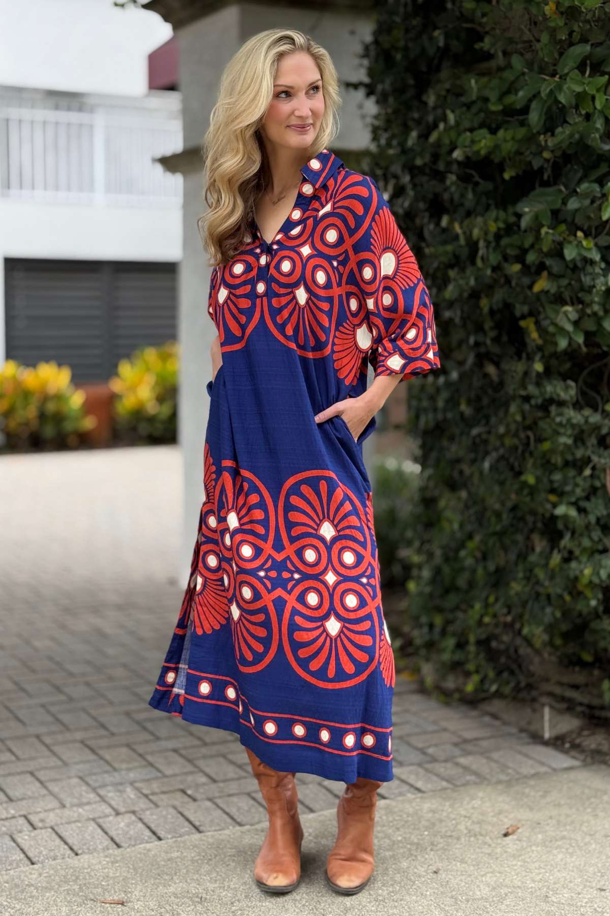 woman wearing The Retro Bloom Midi Dress with navy and red geometric print
