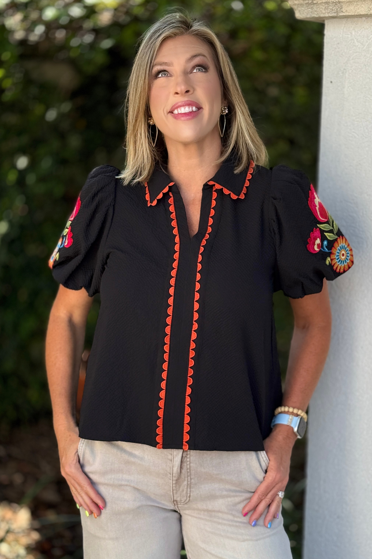 Black textured embroidered puff sleeve top with orange scalloped trim