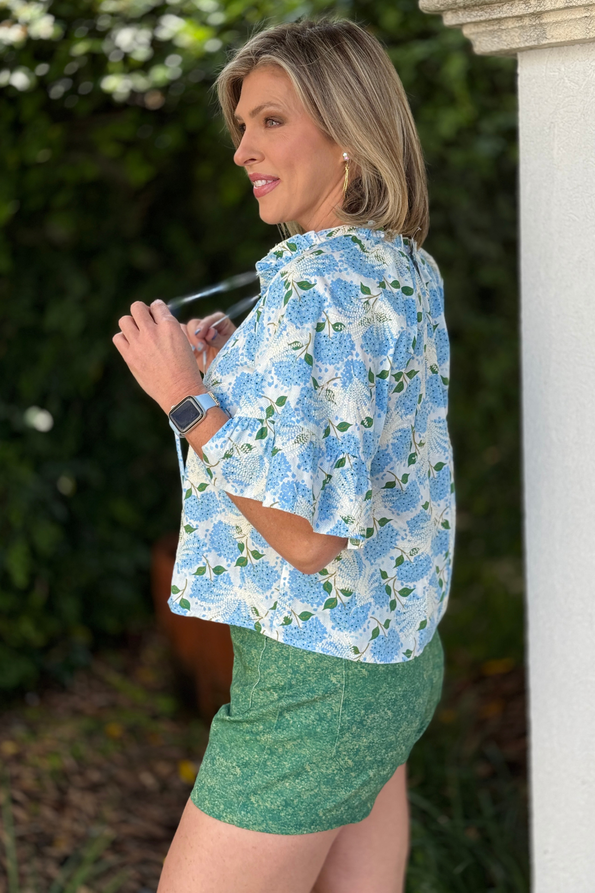women’s blue summer top styled with white pants