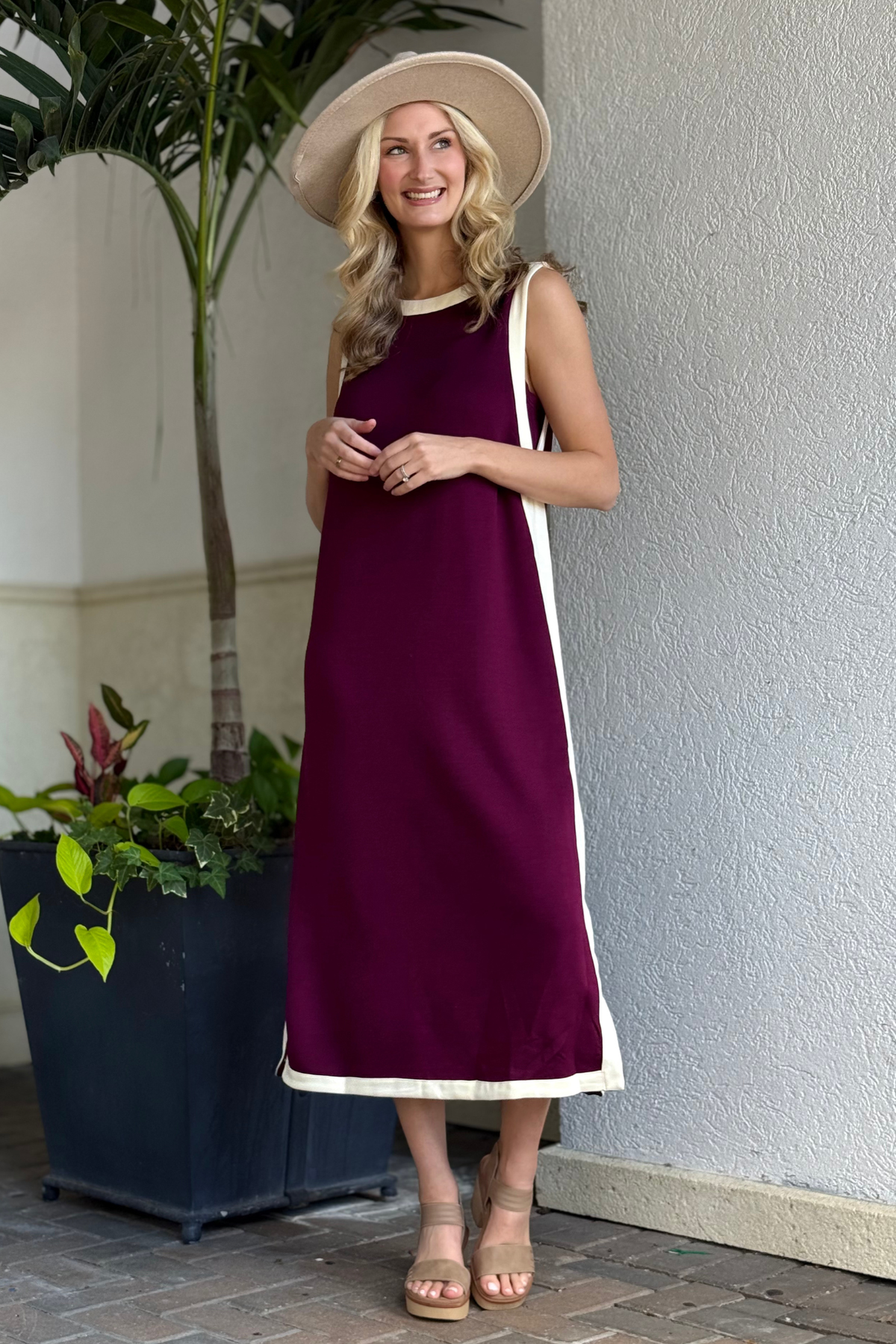 Side view of The Bordeaux Bound Midi Dress featuring contrast cream trim and side slit