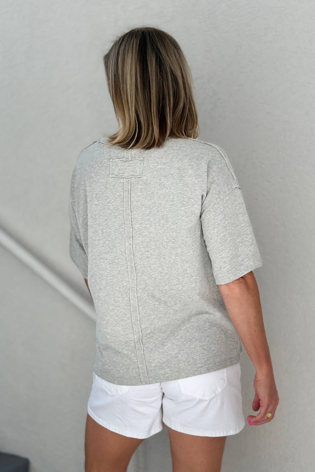 Boutique casual top featuring crowned cat illustration