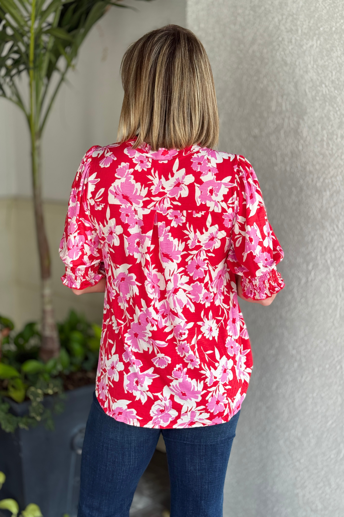 Close-up of smocked cuff detail on floral top