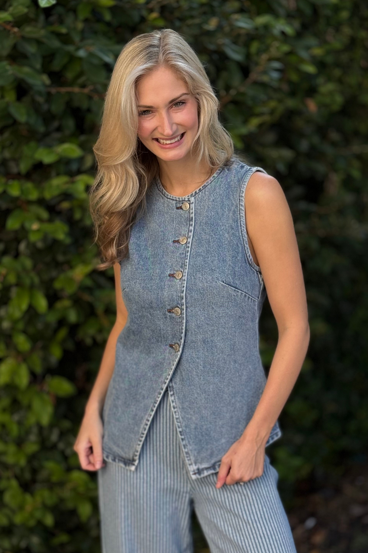 Close-up of crew neckline and metal hardware on The Westwood Classic Denim Vest