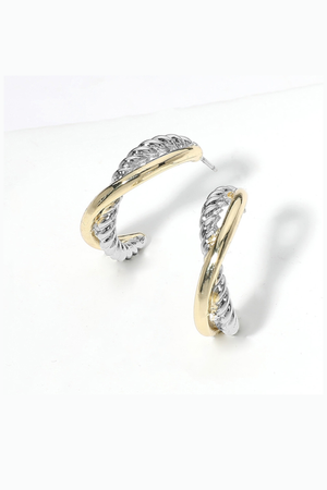 Two-tone twisted hoop earrings with textured silver and smooth gold crossover design
