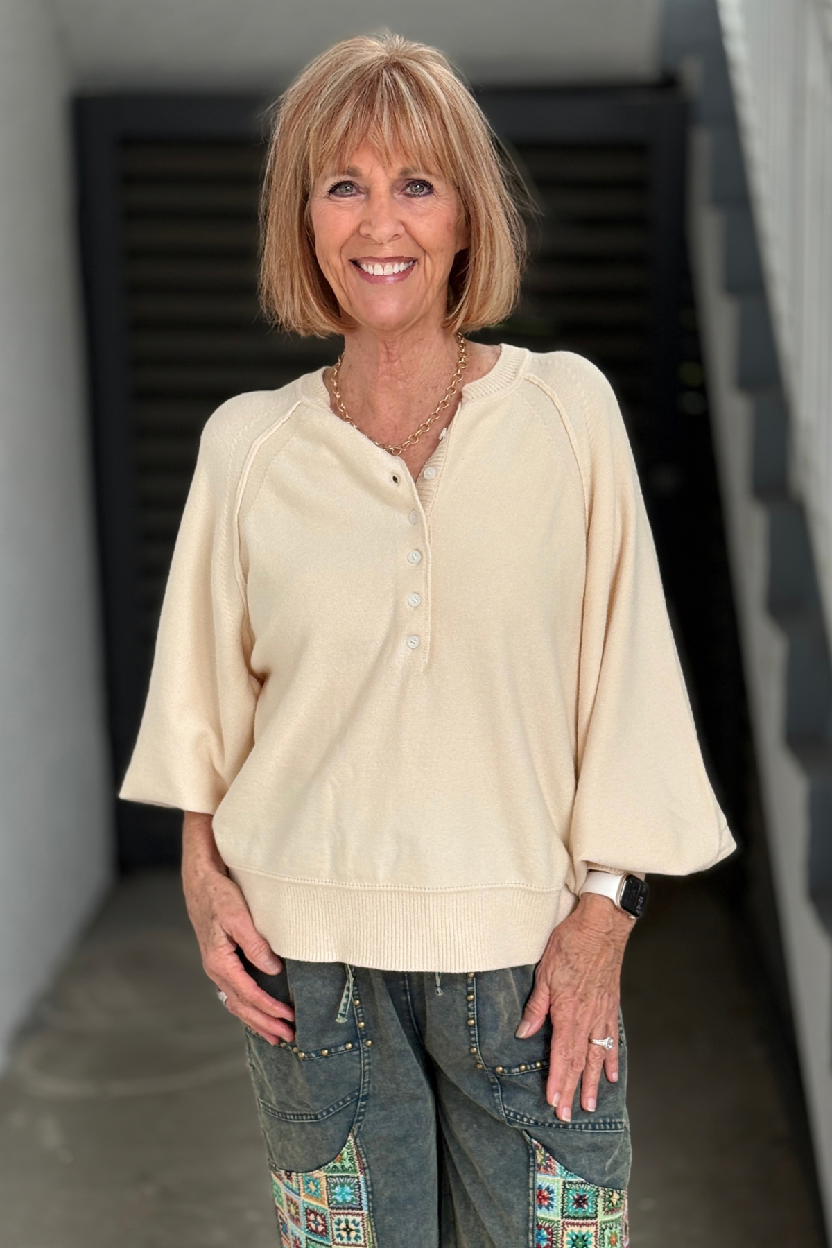 Ivory raglan sleeve sweater top with button neckline  