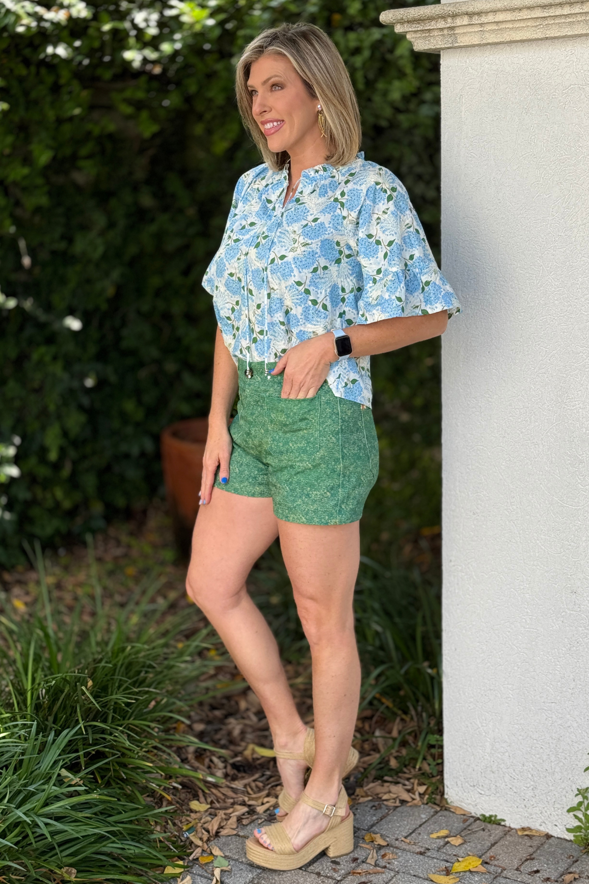 green mineral wash shorts with floral embroidered back pockets