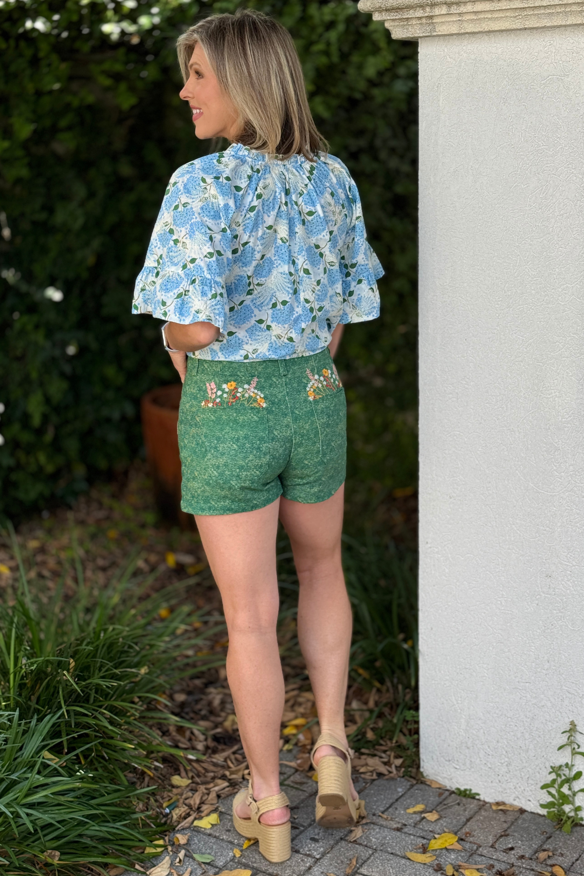 textured green shorts styled with blouse and sandals