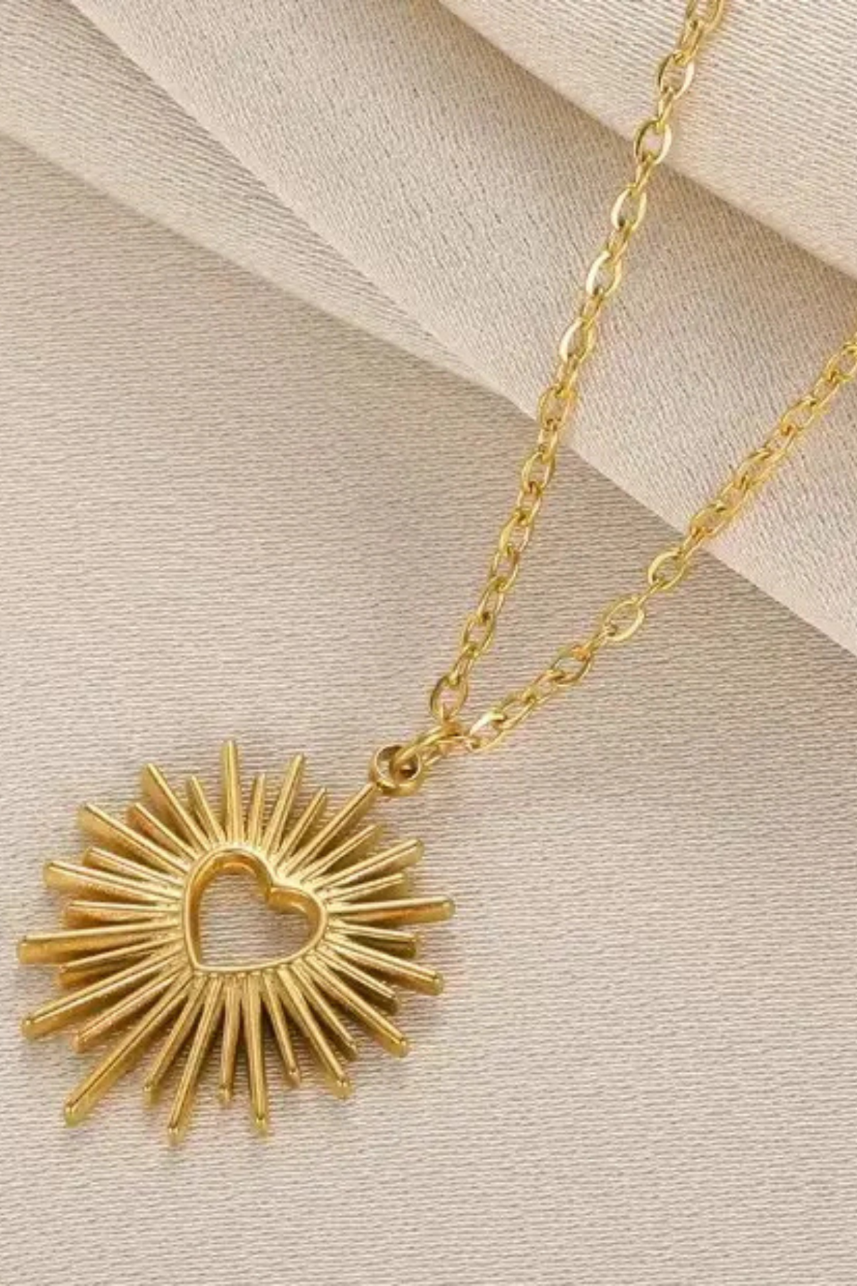 Shop the Golden Radiance Sun Heart Necklace at The Pink Nickel. 18K gold dipped stainless steel, waterproof, tarnish free, hypoallergenic and fade resistant for everyday shine.