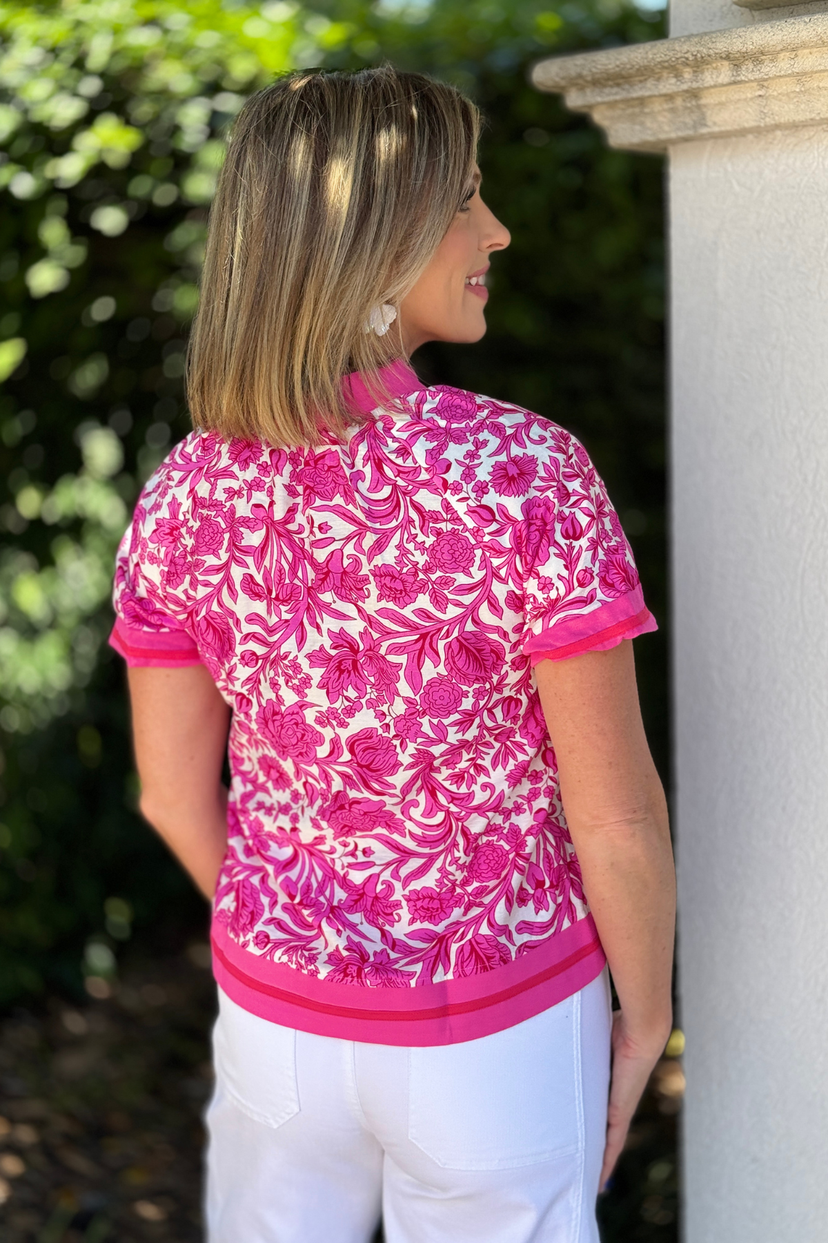 boutique floral shirt styled with white pants