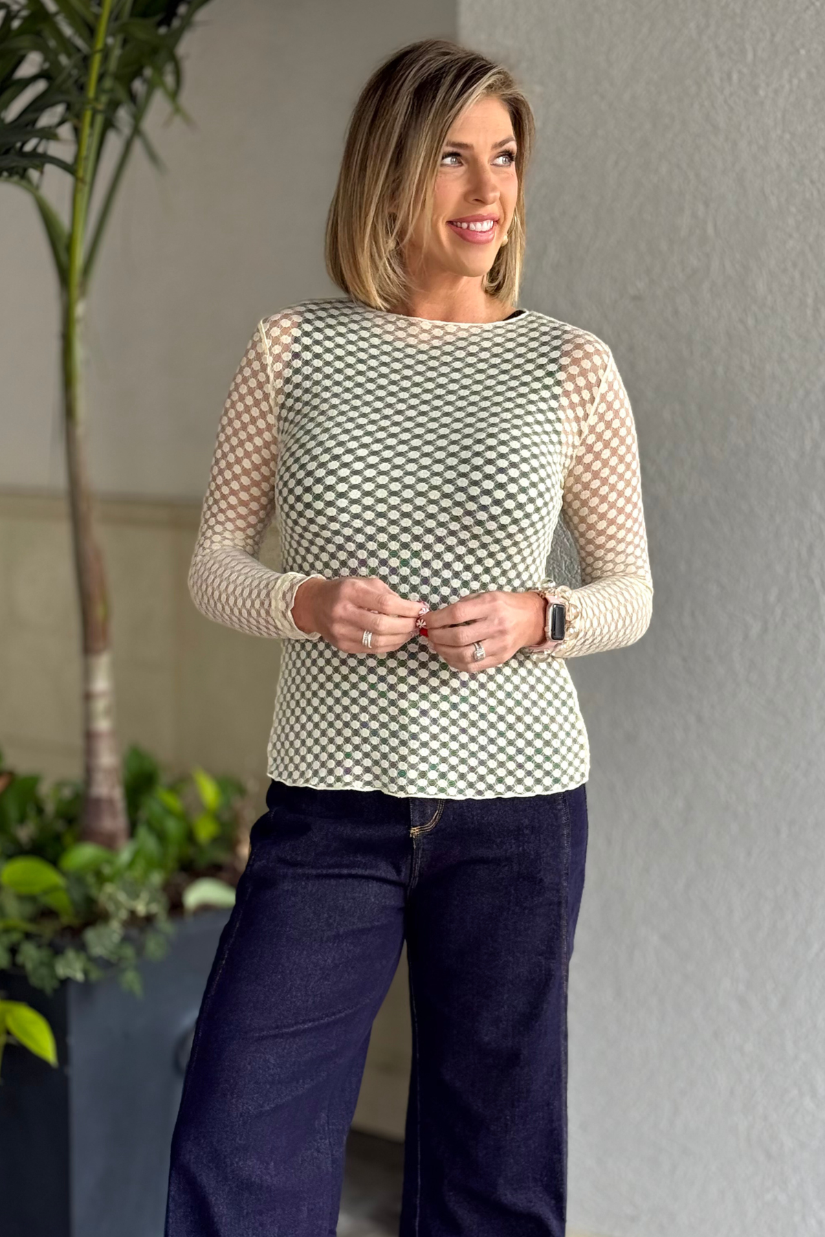 Woman wearing cream dot mesh long sleeve top