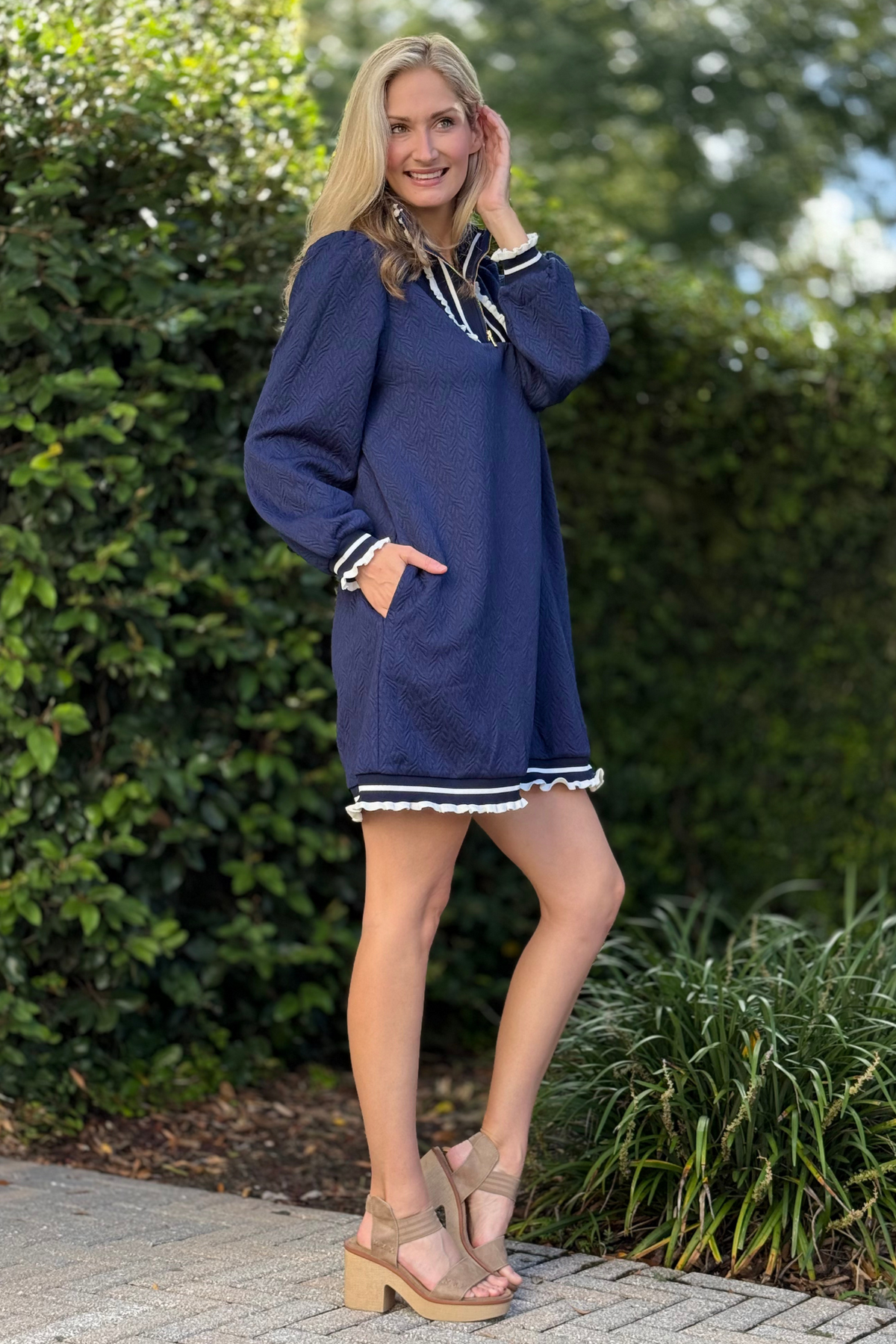 Close-up of half zip neckline and contrast stripe details