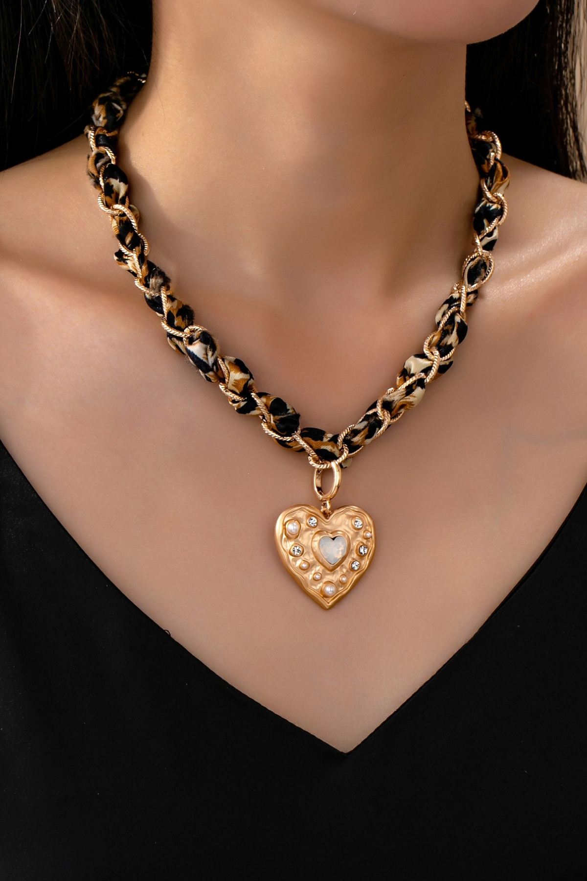 statement animal print heart necklace on model