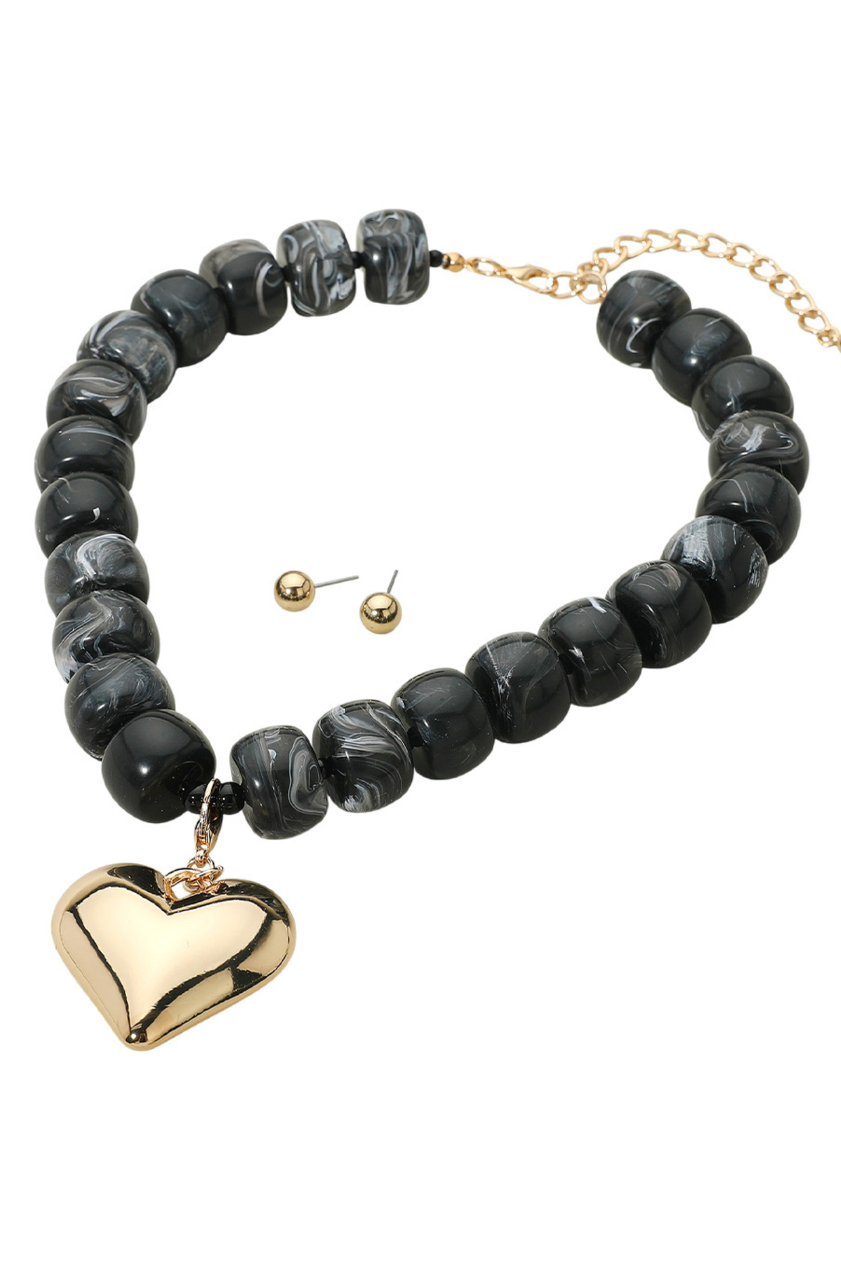 Chunky black marbled bead necklace with gold puffy heart pendant and matching stud earrings.