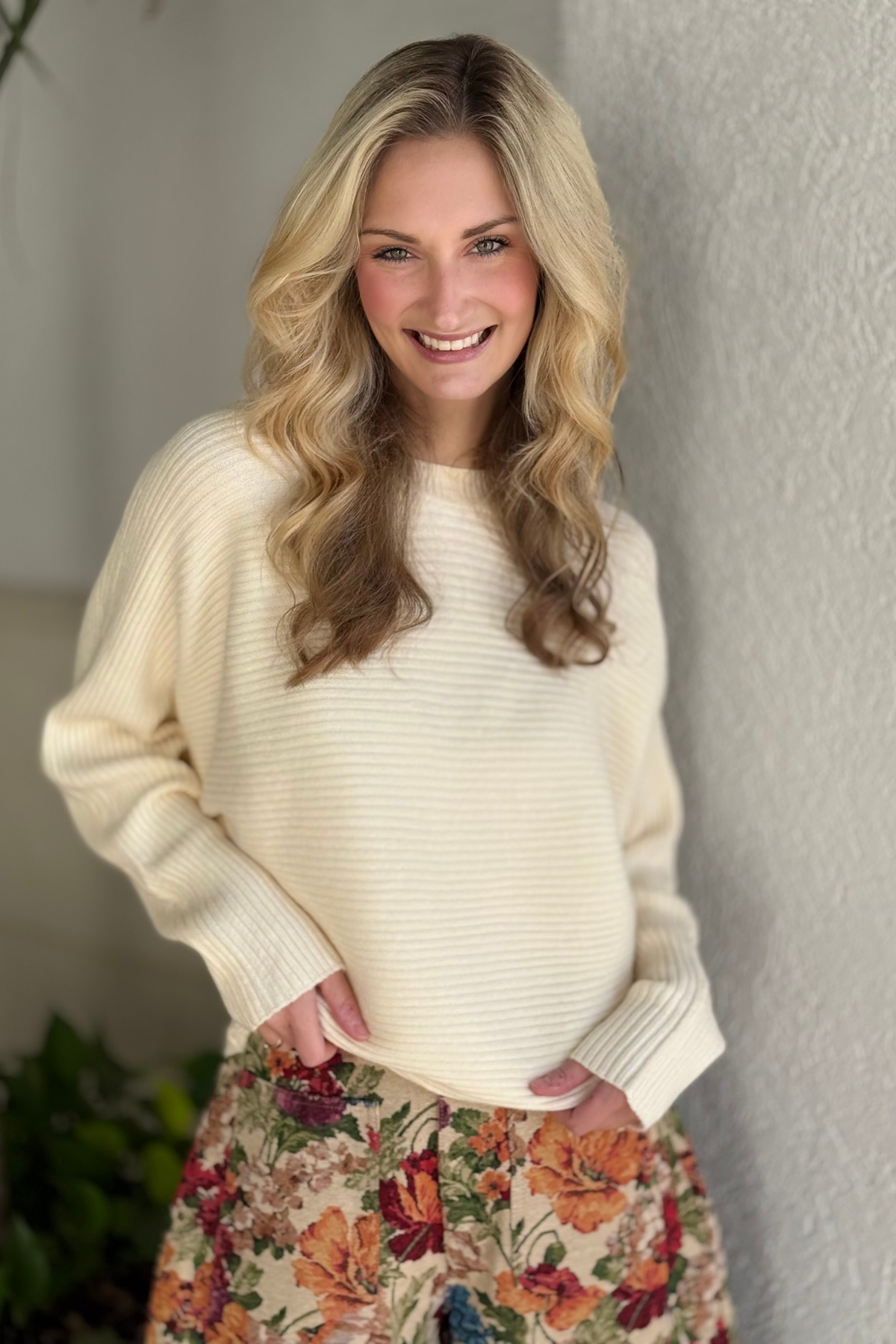 Model wearing cream ribbed batwing sweater side view