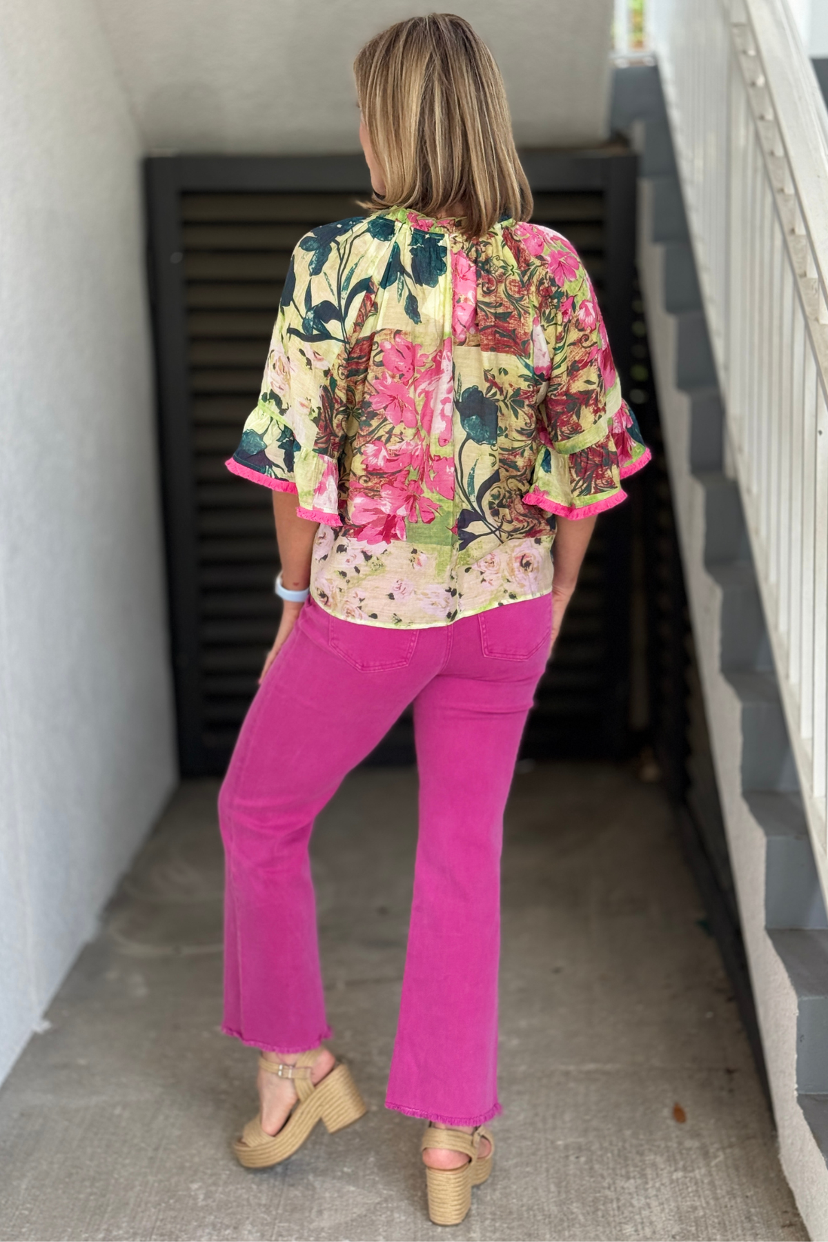 Boho floral top paired with bright pink denim jeans