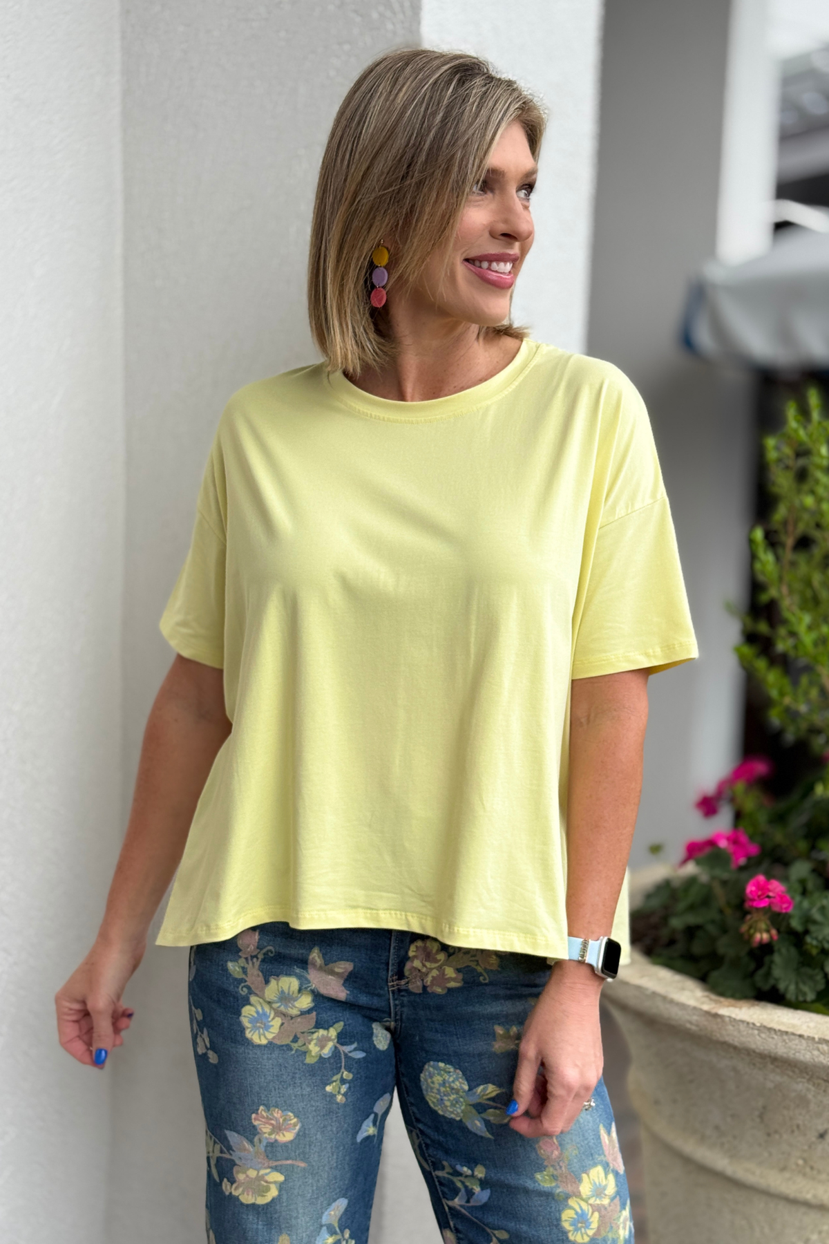 Yellow boxy short sleeve top styled with high waisted floral denim