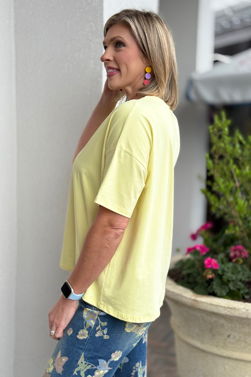 Soft yellow spring top paired with casual denim outfit